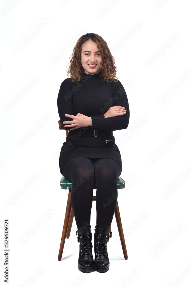 portrait of a woman sitting on a chair in white background, arms crossed portrait of a woman sitting on a chair in white background, arms crossed