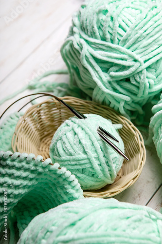 Knitting project in progress.piece of knitting with ball of yarn and a knitting needles