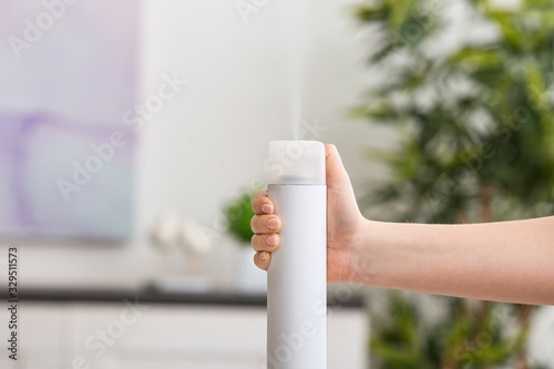 Woman spraying air freshene...