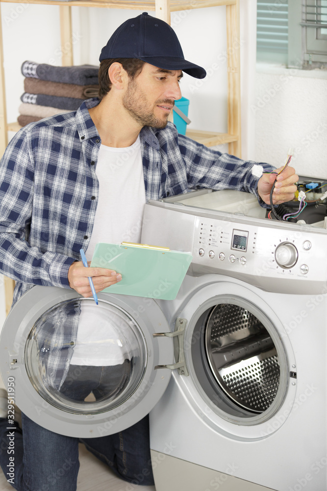 man repairs the electronics of the washing machine man repairs the electronics of the washing machine