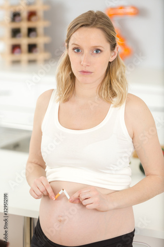 pregnant woman breaks a cigarette in half Free Download pregnant woman breaks a cigarette in half - GFXLoad