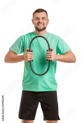 Sporty young man training on white background © Pixel-Shot