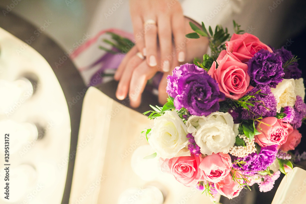 Wedding bridal bouquet on the background of the hands of the newlyweds. Background with copyspace Wedding bridal bouquet on the background of the hands of the newlyweds. Background with copyspace