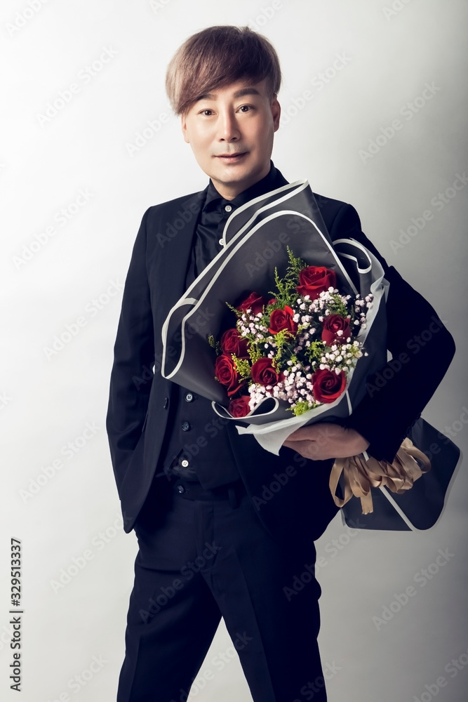 Asian man holding flowers Asian man holding flowers