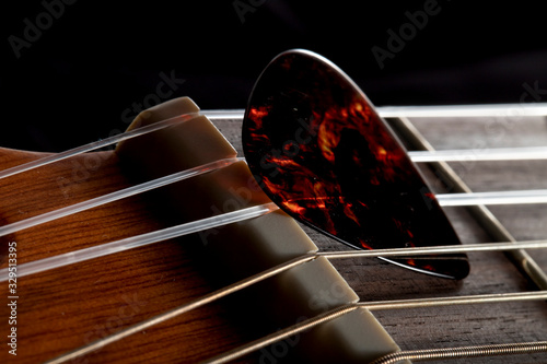 guitar playing pen on the strings closeup, macro look