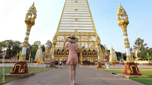 Woman walking Wat Phra That Nong Bua Travel Ubon Ratchathani, Thailand.