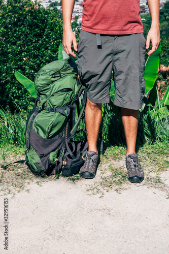 The legs and backpack of the adventurous man