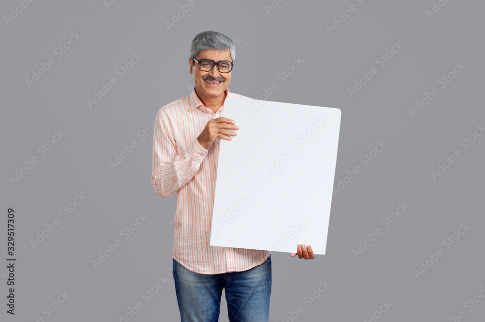 Senior man holding a big square placard in his hand. Senior man holding a big square placard in his hand.
