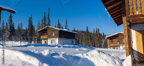 Alpine Village in the ski resort Mountain Salanga. Winter sunny day. Hotel houses photo