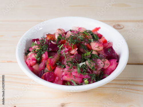 Russian beetroot salad Vinigret in a bowl. Side view
