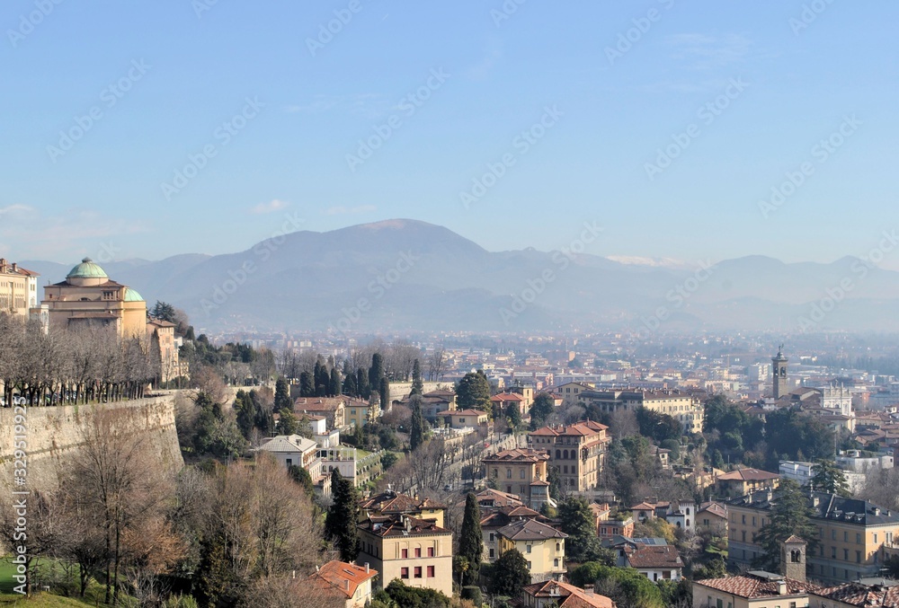 Old medieval Italian town Bergamo city buildings urban exterior historic panorama cityscape blue sky horizon mountains Old medieval Italian town Bergamo city buildings urban exterior historic panorama cityscape blue sky horizon mountains