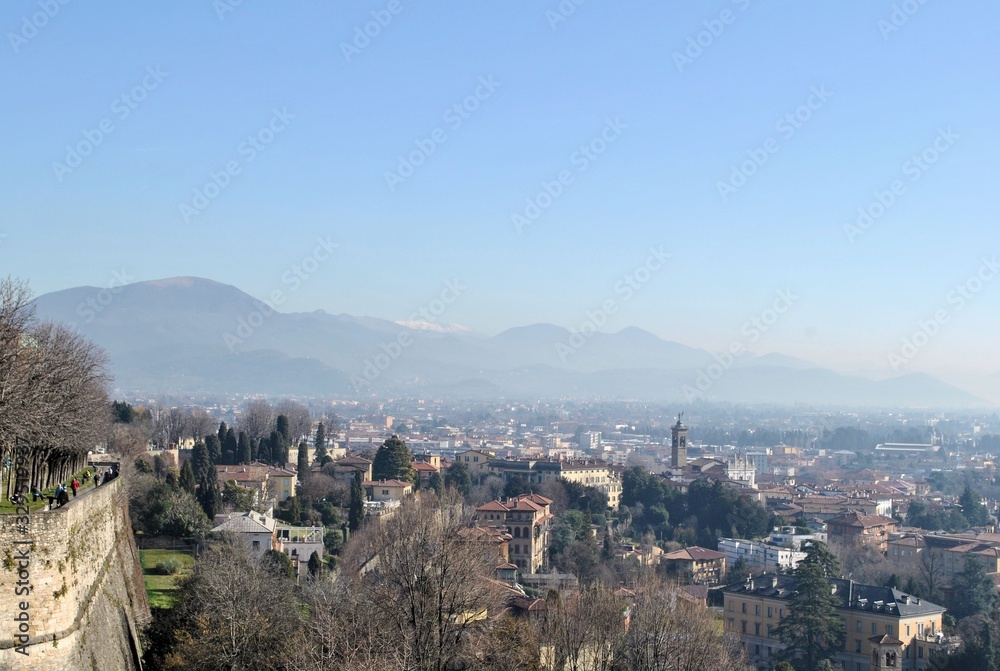Bergamo old Italian town medieval buildings urban panorama beautiful cityscape blue sky horizon mountains