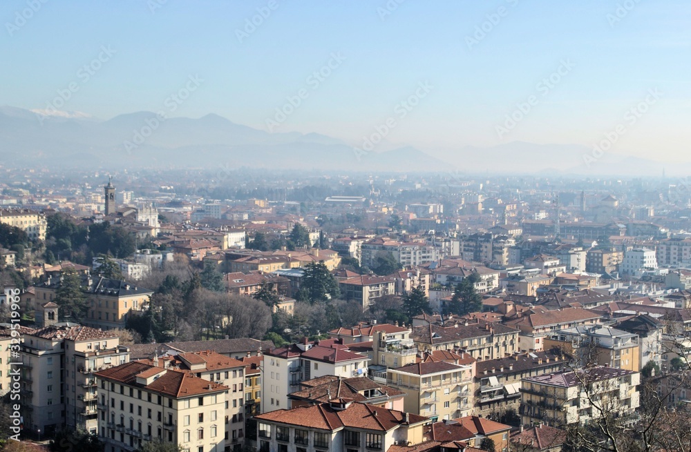 Bergamo old Italian town medieval buildings urban panorama beautiful cityscape blue sky horizon mountains