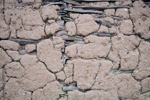 Weathered damaged mud daub on a timber frame wall