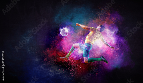 Boy playing soccer hitting the ball