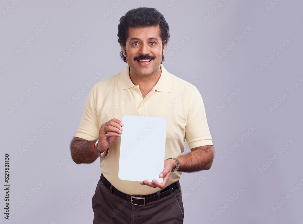 Man in happy mood holding a small placard in hand. Man in happy mood holding a small placard in hand.