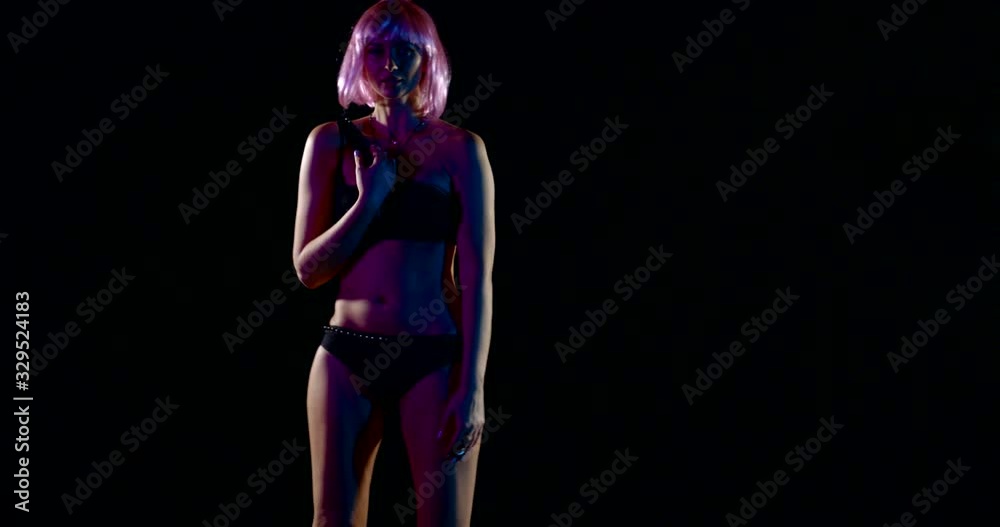 Close-up of the body of a young slender model girl, she has short pink hair, she is in the Studio on a black background, posing, dancing, wearing beautiful black underwear. She has a flat stomach. Close-up of the body of a young slender model girl, she has short pink hair, she is in the Studio on a black background, posing, dancing, wearing beautiful black underwear. She has a flat stomach.