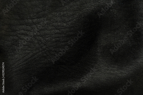 Black leather crumpled surface texture macro shot.
