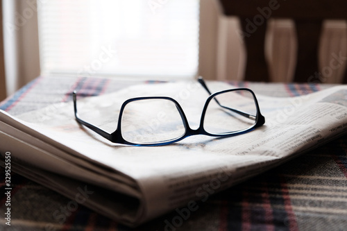 folded newspaper and glasses 
