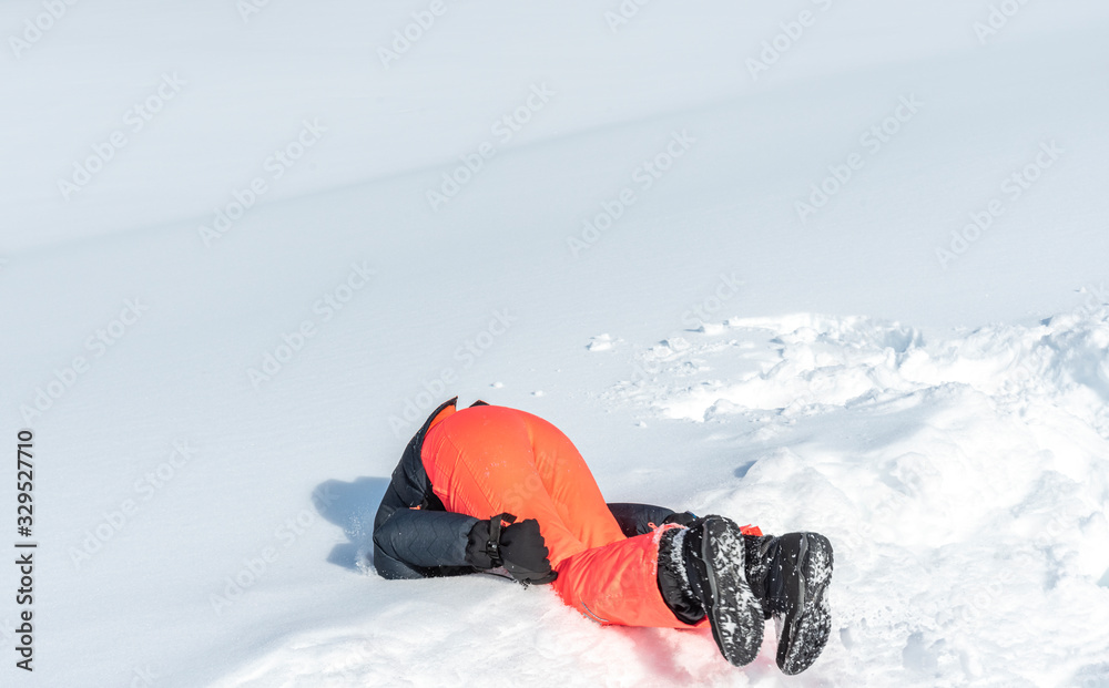 girl landing with her head on the fresh snow
