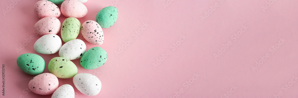 Colorful easter banner, eggs on pink background.