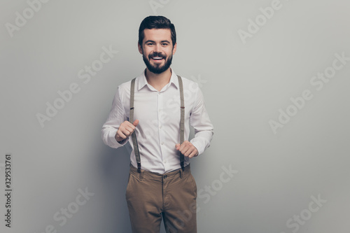 Portrait of candid imposing guy enjoy dream dreamy rest relax pull suspenders wear good look outfit isolated over grey color background © deagreez