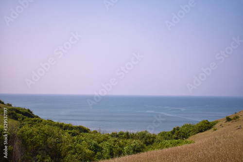 a view of a ocean and the horizon in middle of two mountain