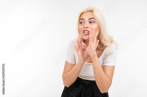 blond girl tells the news on a white studio background with copy space