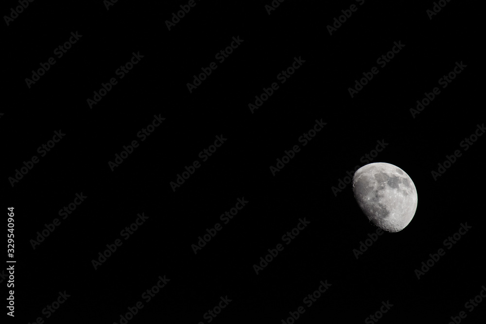 Closeup of a Three Quarter Moon in a Black Sky Closeup of a Three Quarter Moon in a Black Sky