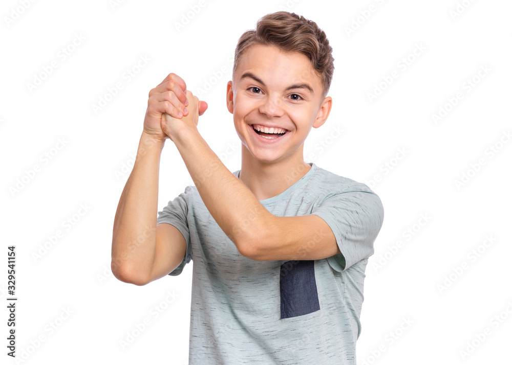 Portrait of happy teen boy showing winning gesture. Successful and celebrating victory, triumphant child making win sign. Handsome caucasian young teenager, isolated on white background. Portrait of happy teen boy showing winning gesture. Successful and celebrating victory, triumphant child making win sign. Handsome caucasian young teenager, isolated on white background.