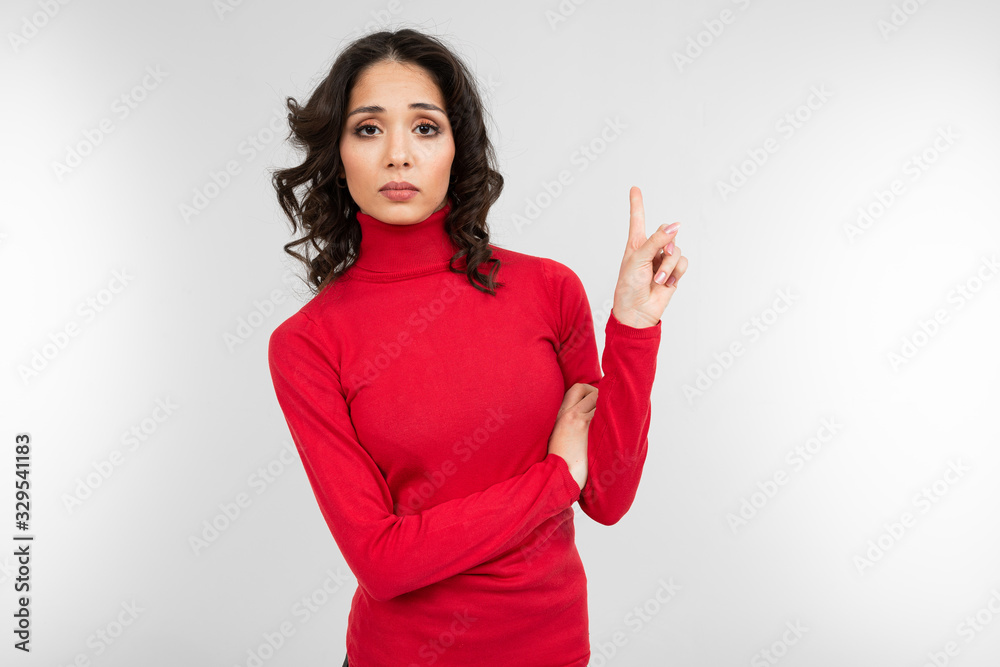 brunette girl shows about the presence of ideas in her voice on a white studio background brunette girl shows about the presence of ideas in her voice on a white studio background