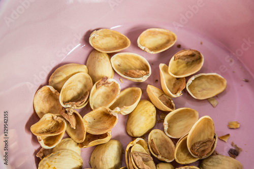 Pistachio shells in pink bowl