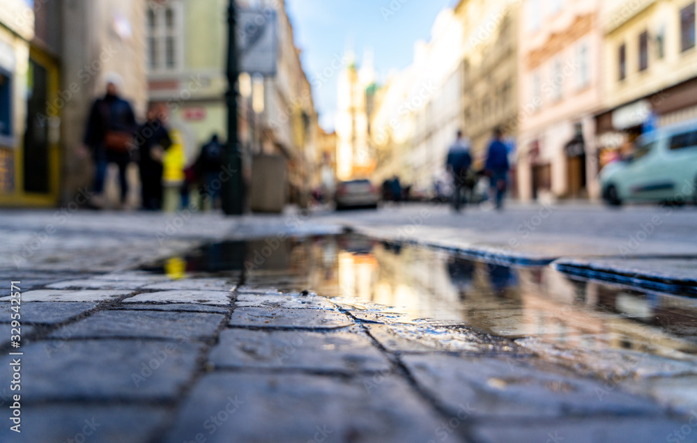 City reflection on water puddle cobblestone