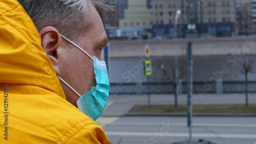 Sick man in medical mask outdoors photo