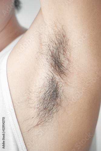 Close up underarm of man hands and shows unshaven armpit