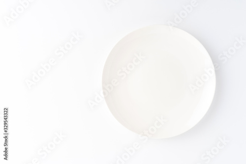 Empty white dish isolated on white table. Top view