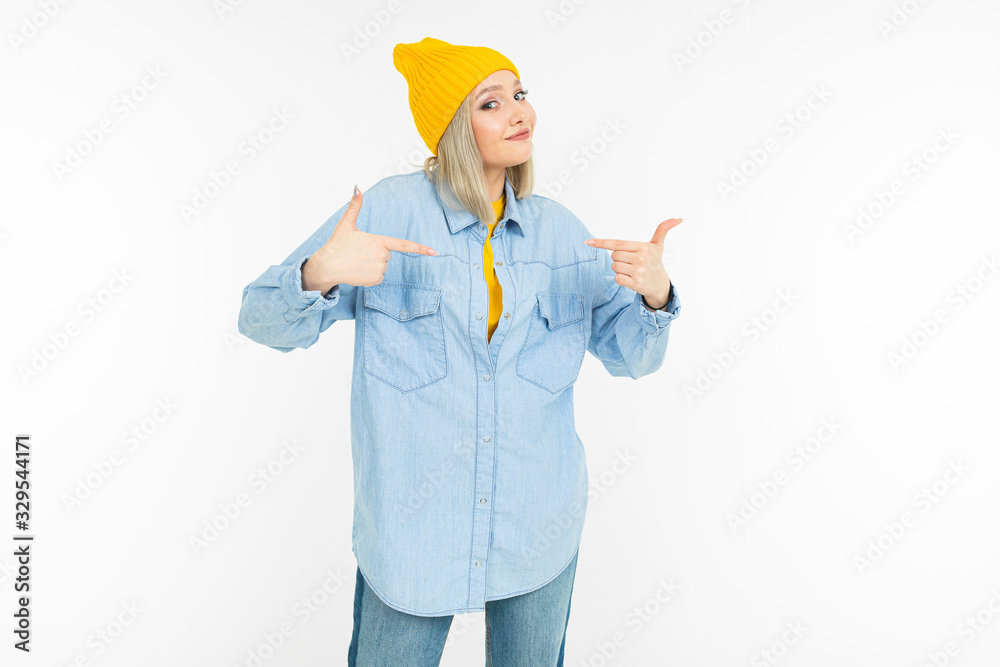 blond girl in a stylish denim shirt and a yellow jacket on a white background blond girl in a stylish denim shirt and a yellow jacket on a white background