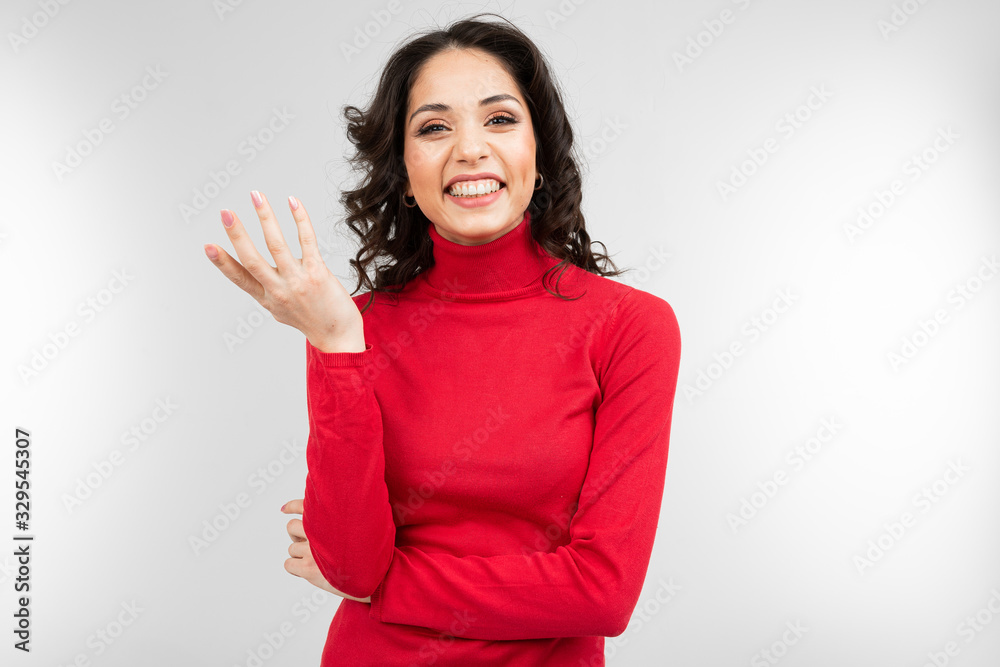 pensive brunette in a red turtleneck on a white studio background pensive brunette in a red turtleneck on a white studio background
