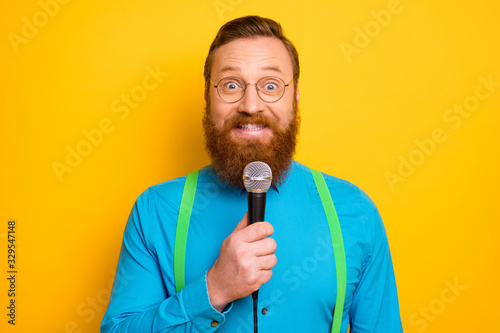 Close up photo of positive cheerful man broadcasting rock-and-roll concert hold mic sing song wear look modern funky outfit isolated over shine color background