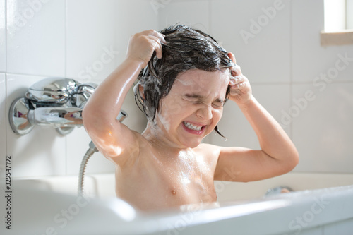 4 year old boy shampooing in the bathtub