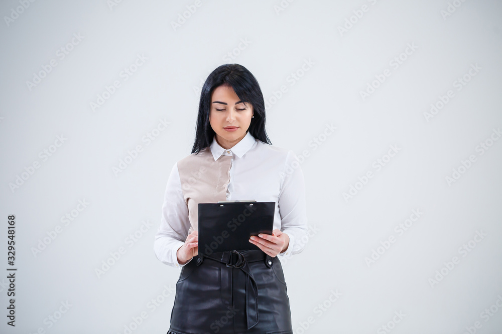 woman teacher, business coach, mentor holds a folder with a new business project in her hands woman teacher, business coach, mentor holds a folder with a new business project in her hands