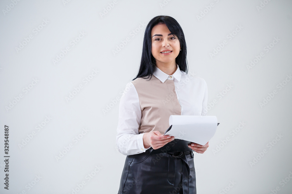 woman teacher, business coach, mentor holds a folder with a new business project in her hands woman teacher, business coach, mentor holds a folder with a new business project in her hands