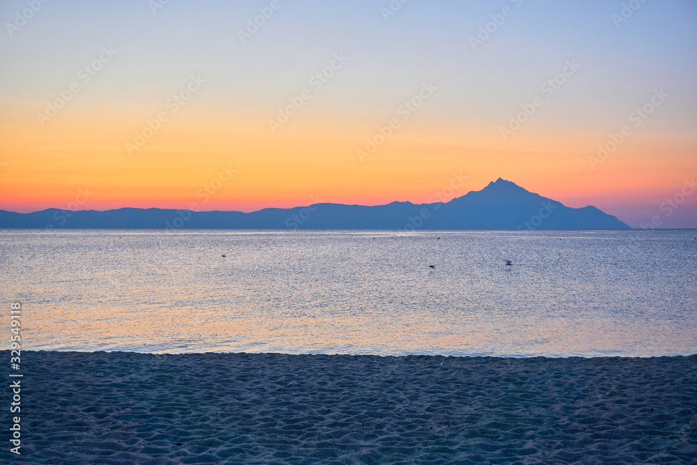 Wonderful sunrise view behind the mountains and next to the sea Wonderful sunrise view behind the mountains and next to the sea