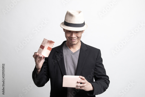 Adult Asian man open a gift box.