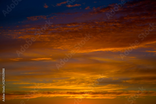 Fiery orange sunset sky. Beautiful sky. Bright orange and yellow colors sunset sky. © Alik Mulikov