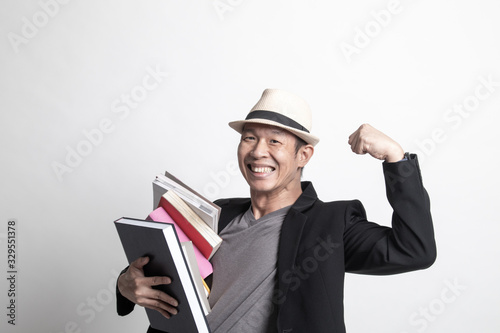 Adult Asian man studying  with may books.