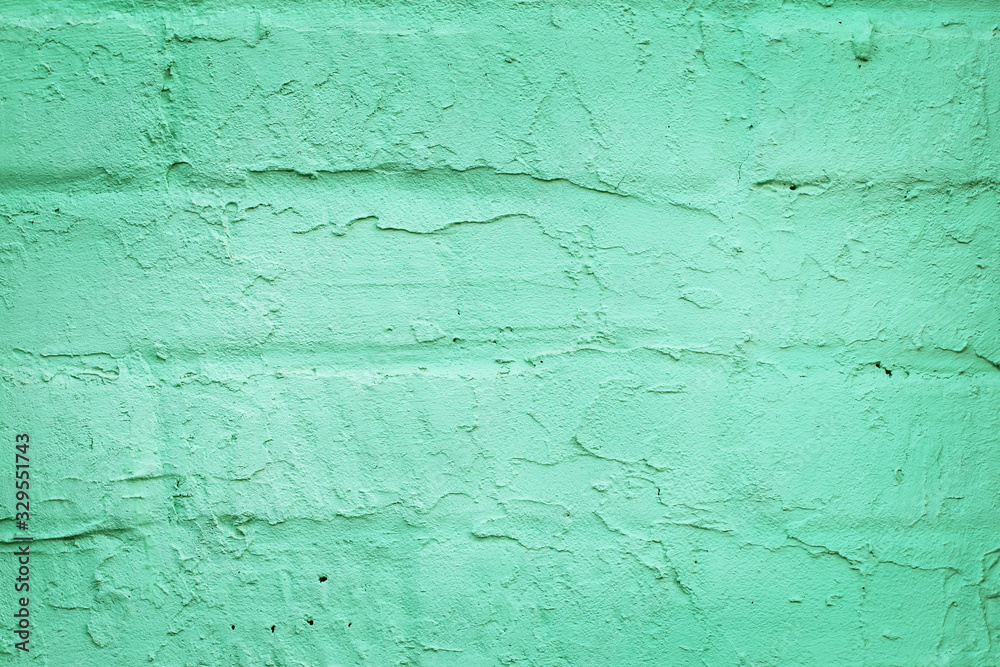 Closeup part of a brick wall covered with trendy turquoise or mint color plaster. Abstract modern texture background Closeup part of a brick wall covered with trendy turquoise or mint color plaster. Abstract modern texture background