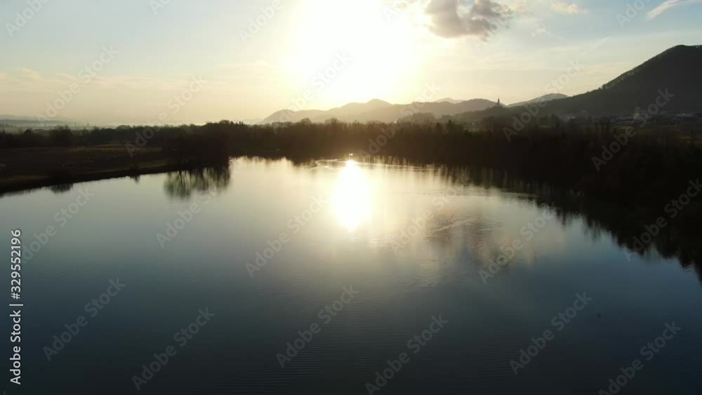Ribnik Vrbje fishing lake in eastern Slovenia Europe during sunset, Aerial low flyover shot Ribnik Vrbje fishing lake in eastern Slovenia Europe during sunset, Aerial low flyover shot