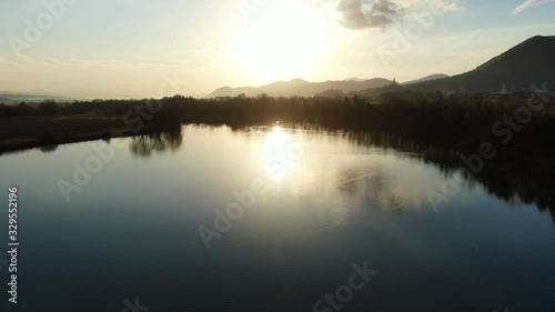 Ribnik Vrbje fishing lake in eastern Slovenia Europe during sunset, Aerial low flyover shot photo