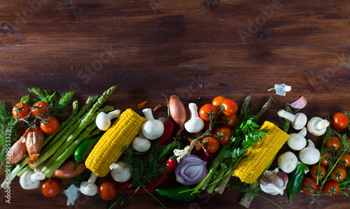 Wooden background with vegetables, mushrooms, greens photo